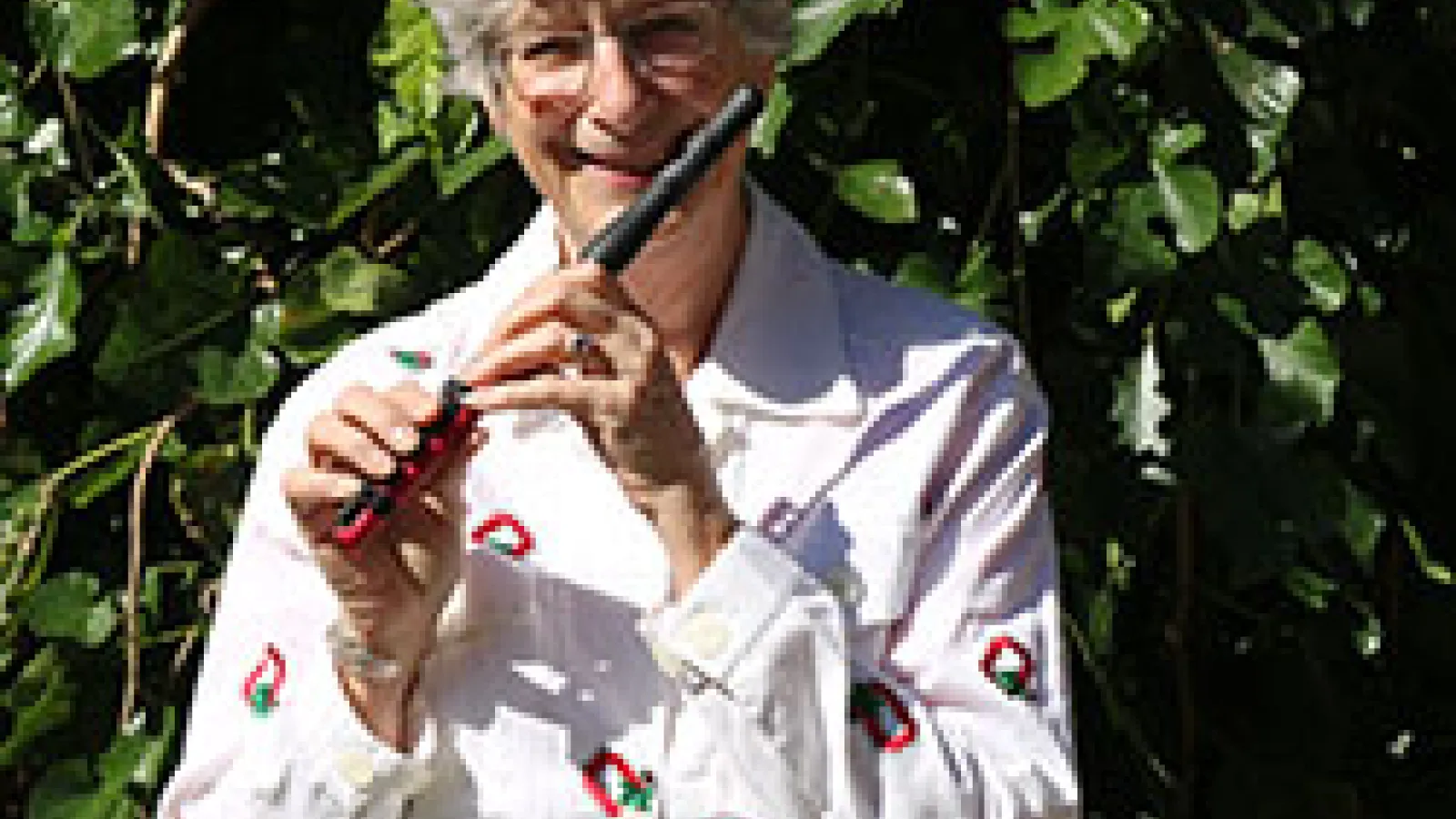 Professor Katherine Borst Jones poses with her red composite piccolo