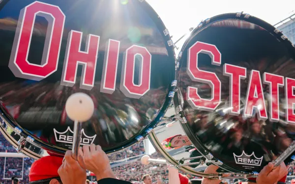 Ohio and State bass drums on heads of students